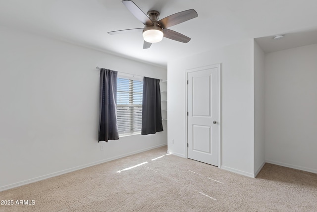 unfurnished bedroom with light colored carpet and ceiling fan