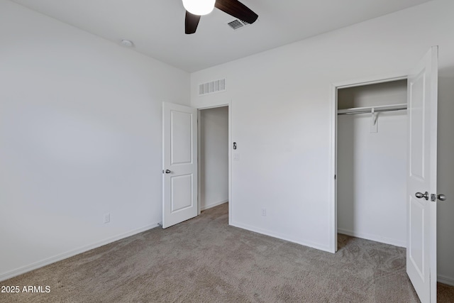 unfurnished bedroom featuring light colored carpet, a closet, and ceiling fan