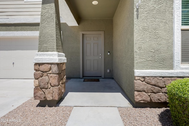 entrance to property featuring a garage