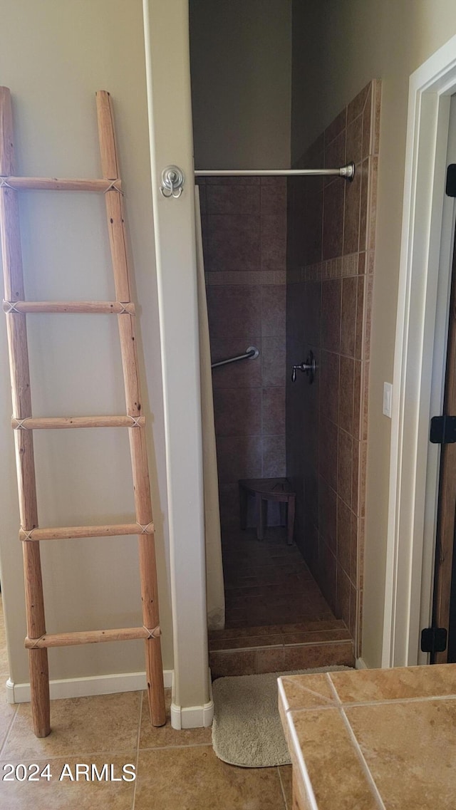 bathroom featuring tile patterned floors and tiled shower