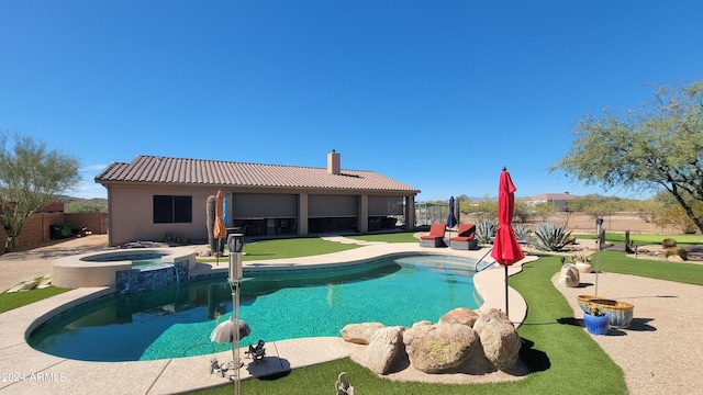 view of swimming pool with a patio and an in ground hot tub