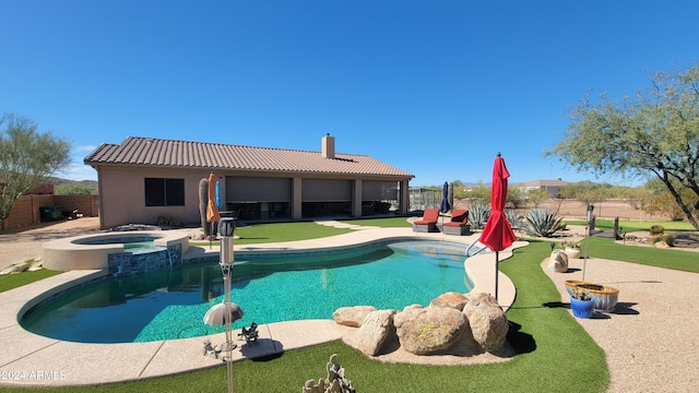 view of swimming pool featuring a patio area and an in ground hot tub