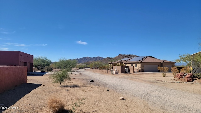 view of yard with a garage and a mountain view