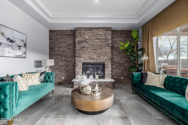 living room featuring a fireplace and a raised ceiling