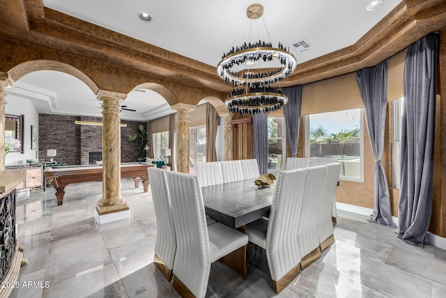 dining space with pool table, a raised ceiling, and decorative columns