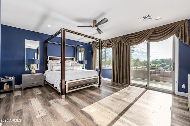 bedroom featuring access to exterior, hardwood / wood-style floors, and ceiling fan