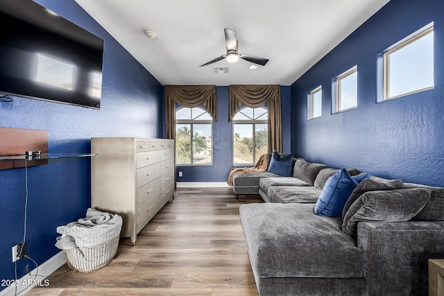 living room with hardwood / wood-style flooring and ceiling fan