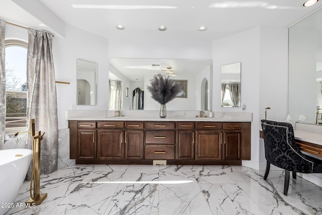 bathroom featuring a bathing tub, plenty of natural light, and vanity