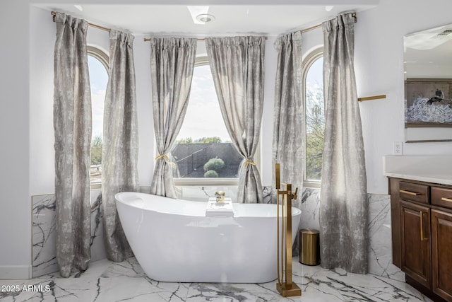 bathroom with vanity and a tub to relax in