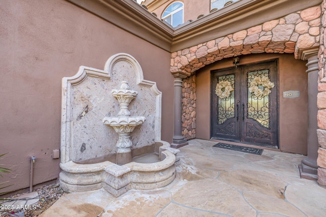 entrance to property featuring french doors