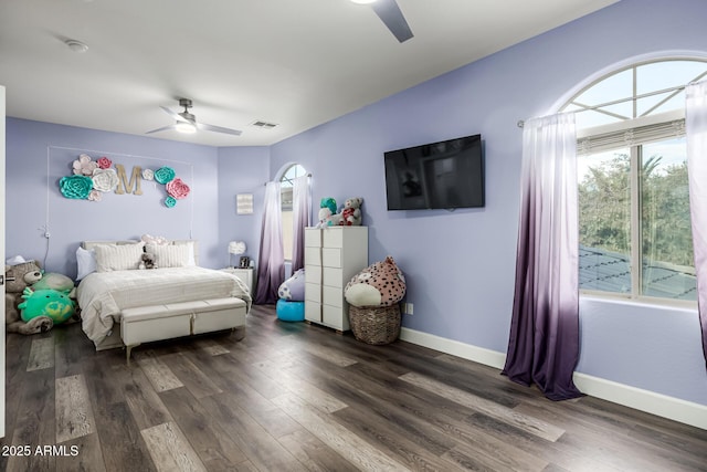 bedroom with dark hardwood / wood-style floors and ceiling fan