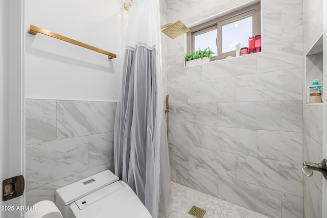 bathroom featuring toilet, tile walls, and a shower with shower curtain