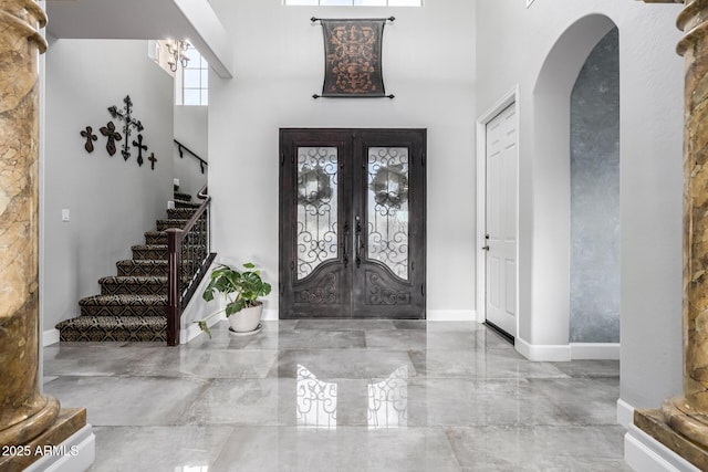 foyer entrance featuring french doors and a high ceiling