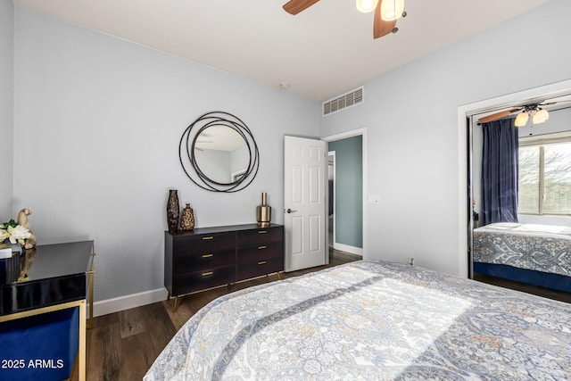 bedroom with dark wood-type flooring, ceiling fan, and a closet