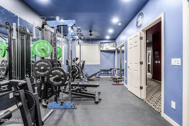 exercise room with ceiling fan