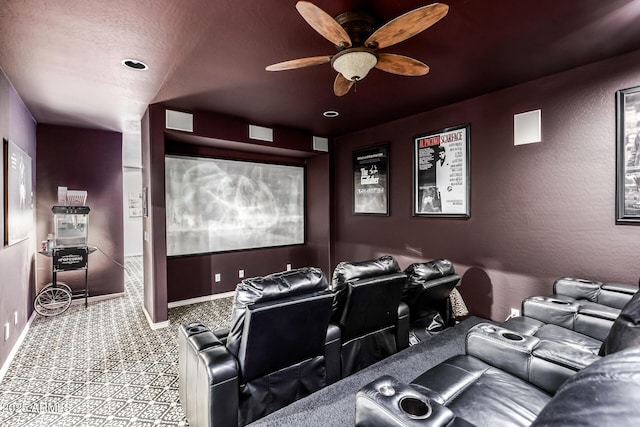 carpeted home theater room with ceiling fan