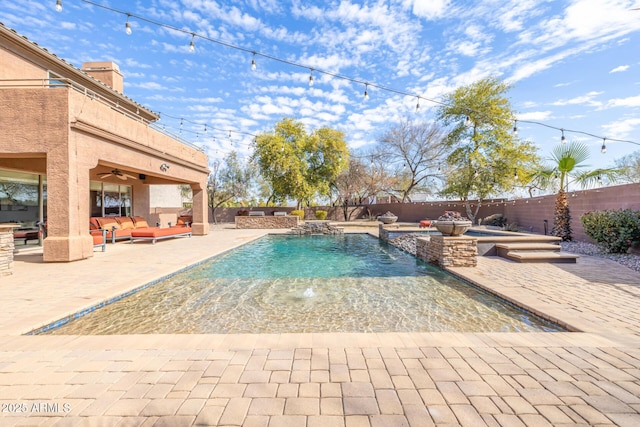 view of pool with pool water feature, a jacuzzi, ceiling fan, an outdoor living space, and a patio