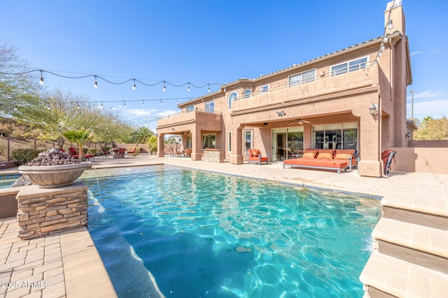 view of pool featuring a patio, outdoor lounge area, and ceiling fan