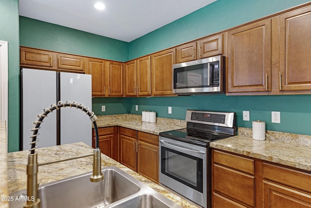 1316 S Minneola Ln, Gilbert, AZ 85296 - kitchen with stainless steel appliances and brown cabinetry