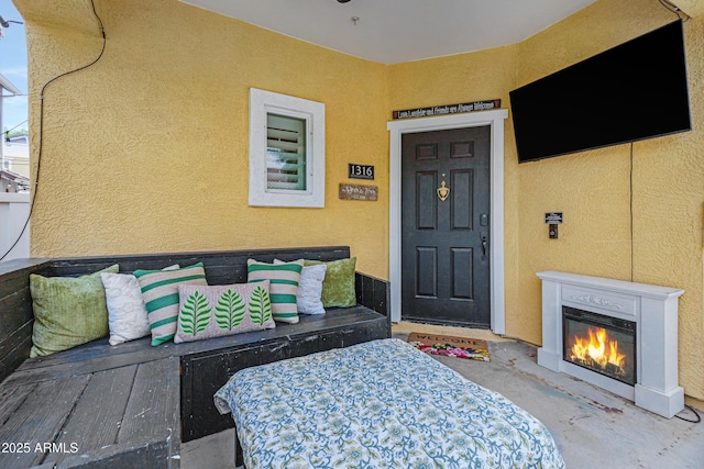 1316 S Minneola Ln, Gilbert, AZ 85296 - doorway to property featuring stucco siding and a glass covered fireplace