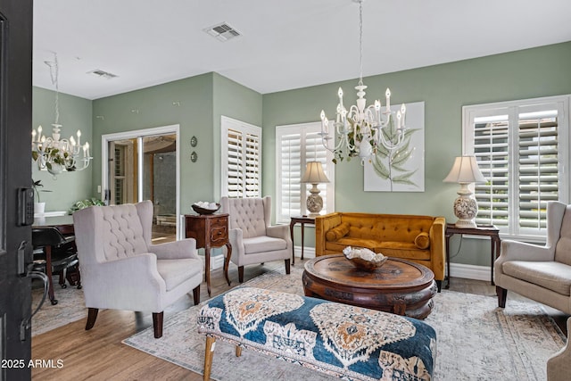 1316 S Minneola Ln, Gilbert, AZ 85296 - living area featuring a chandelier, wood finished floors, and baseboards