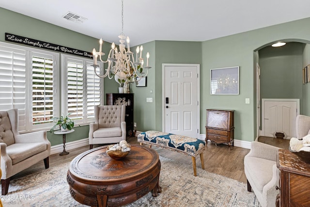 1316 S Minneola Ln, Gilbert, AZ 85296 - sitting room with arched walkways, wood finished floors, a chandelier, and baseboards