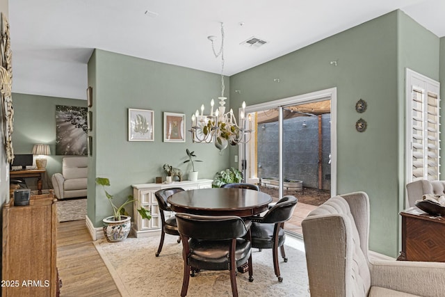 1316 S Minneola Ln, Gilbert, AZ 85296 - dining area featuring wood finished floors, a chandelier, and baseboards