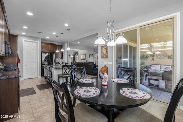 dining area with sink and light tile patterned flooring