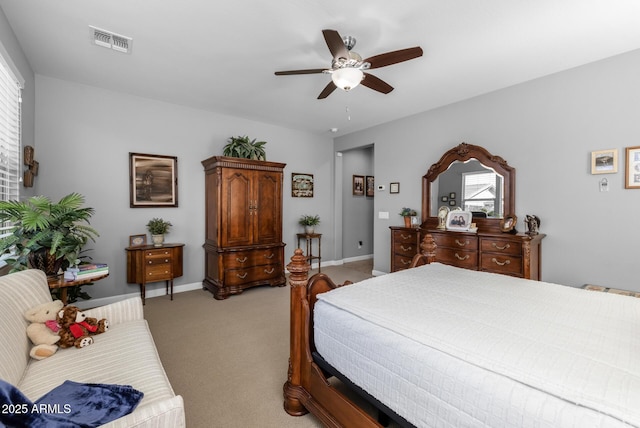 carpeted bedroom with multiple windows and ceiling fan