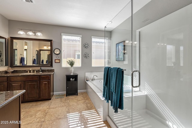 bathroom featuring vanity, tile patterned flooring, and plus walk in shower