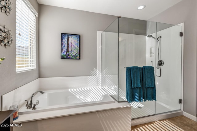 bathroom with separate shower and tub