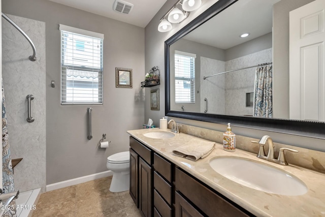 bathroom featuring a shower with curtain, vanity, and toilet