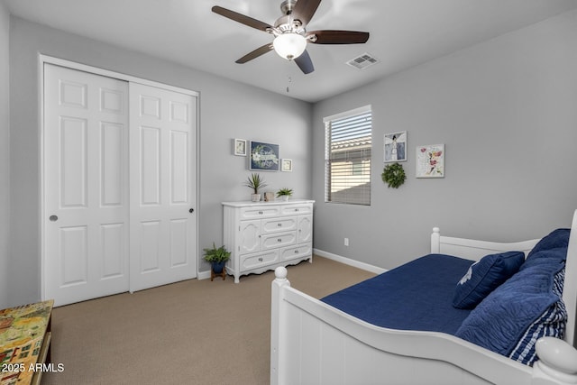 bedroom featuring ceiling fan, a closet, and carpet