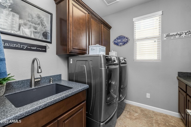 laundry room with cabinets, separate washer and dryer, and sink