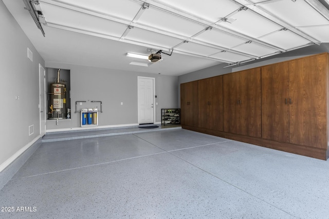 garage featuring water heater and a garage door opener