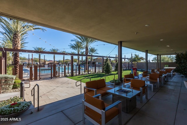 view of patio with a community pool and an outdoor fire pit