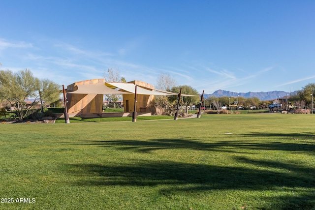 view of home's community featuring a mountain view and a lawn