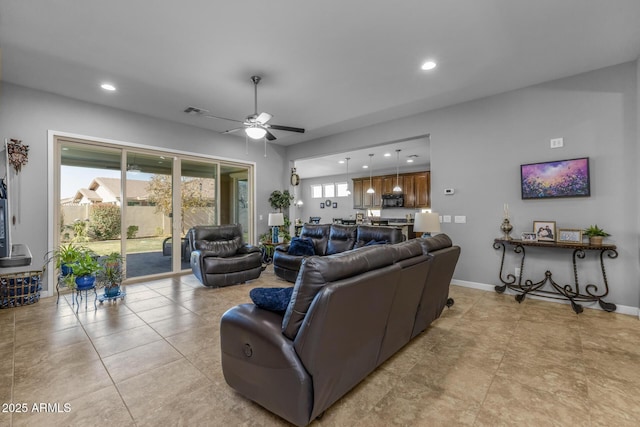 tiled living room with ceiling fan