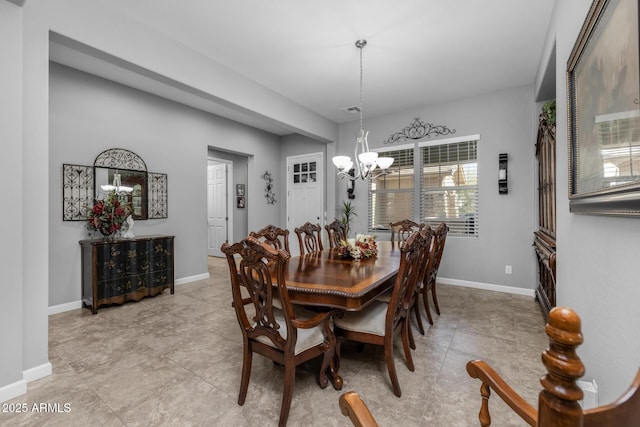 dining space with an inviting chandelier