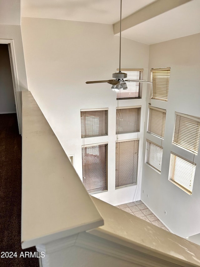 room details featuring ceiling fan and beamed ceiling