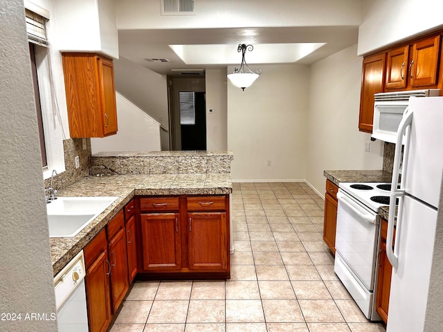 kitchen with kitchen peninsula, white appliances, sink, light tile patterned floors, and hanging light fixtures