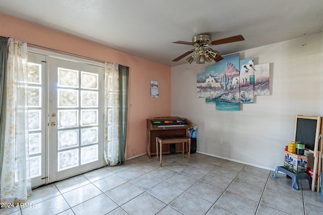 doorway to outside featuring light tile patterned floors and ceiling fan