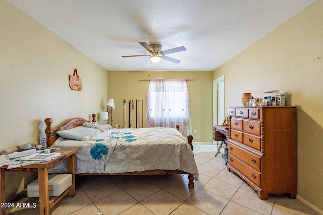 tiled bedroom featuring a textured ceiling and ceiling fan