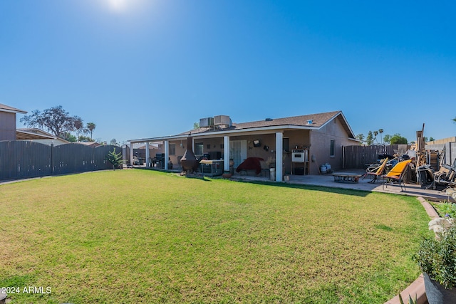 back of house featuring a yard and a patio area