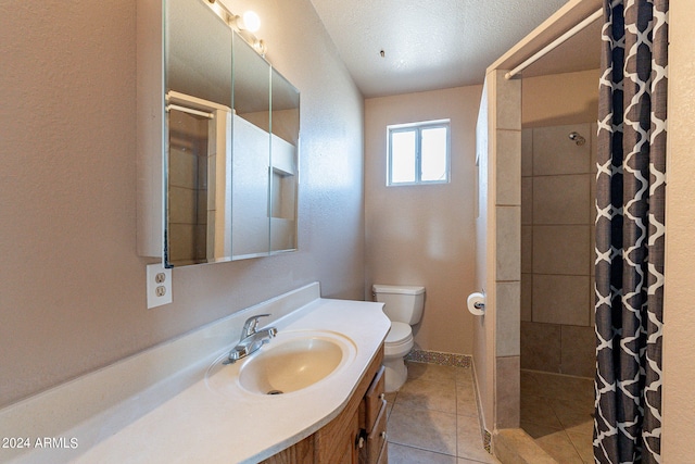 bathroom featuring toilet, tile patterned flooring, a shower with curtain, vanity, and a textured ceiling