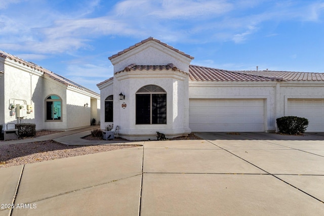 mediterranean / spanish-style home with a garage