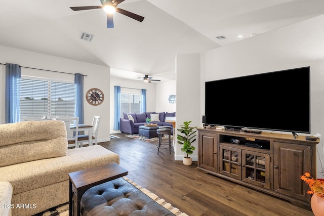 living room featuring ceiling fan, dark wood-type flooring, and vaulted ceiling