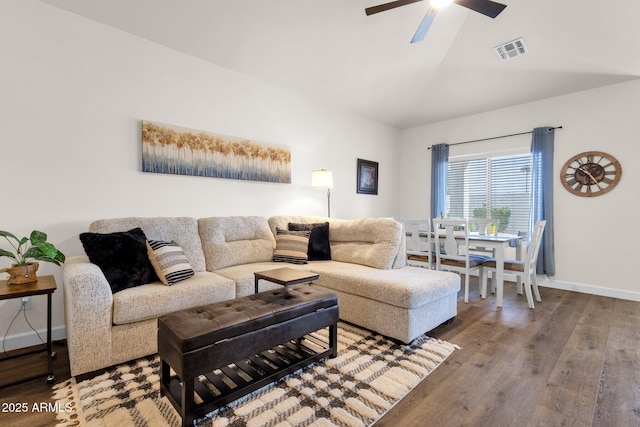 living room with ceiling fan, hardwood / wood-style floors, and lofted ceiling