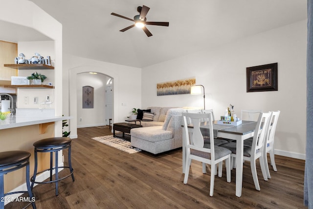 dining room with dark hardwood / wood-style flooring and ceiling fan