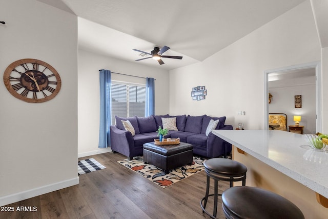 living room with ceiling fan and dark hardwood / wood-style floors